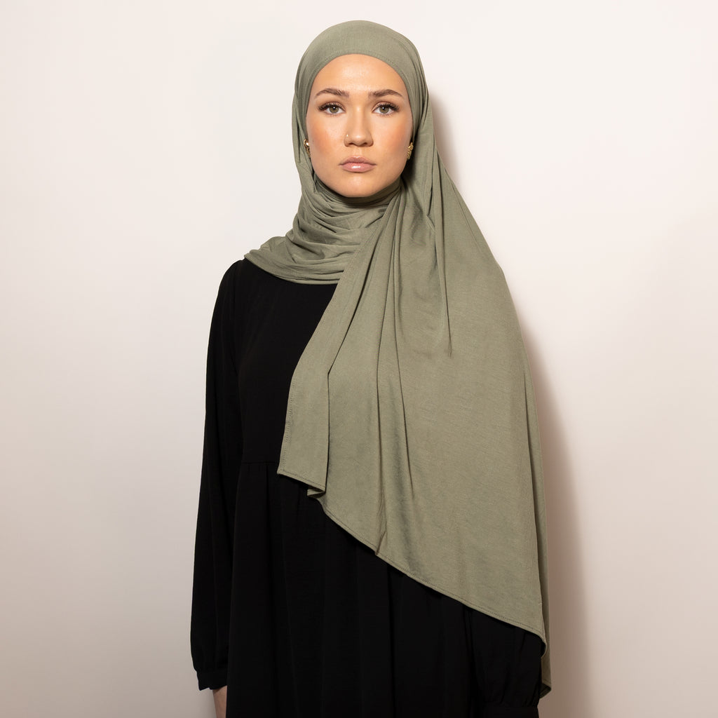 Nainen puettuna tyylikkäästi Bamboo Jersey Deep Sand Hijab huiviin